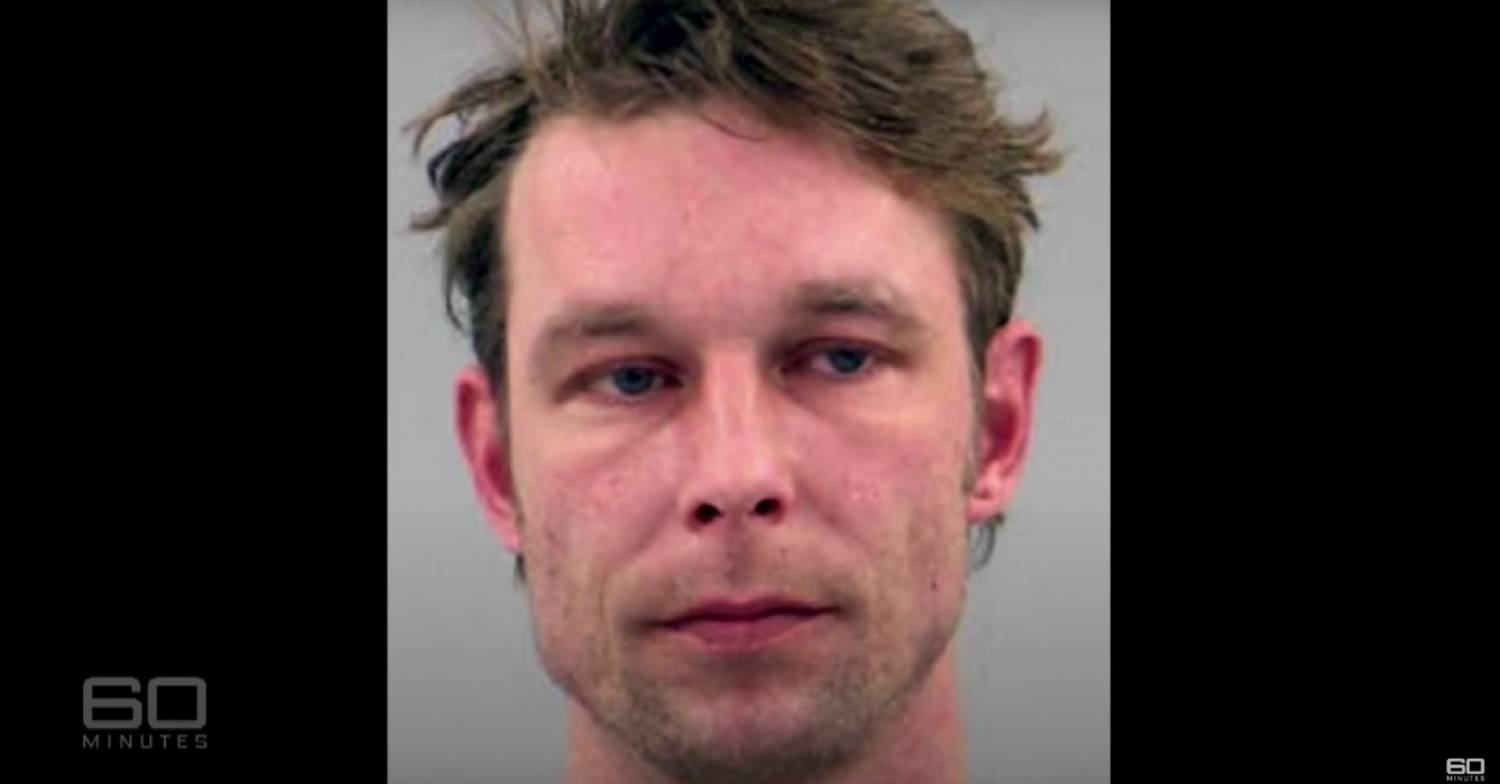 Christian B looks to the side in mugshot