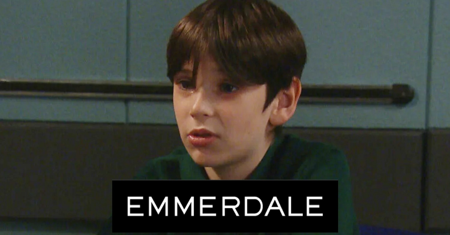 Emmerdale's Kyle looking worried in the police station with the Emmerdale logo comp image