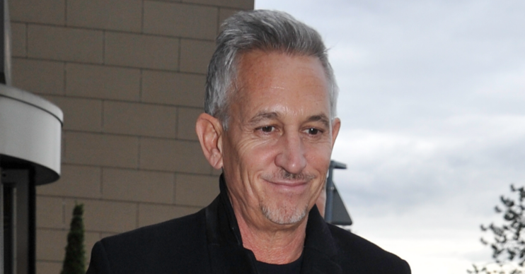Gary Lineker looking down in the street in a coat