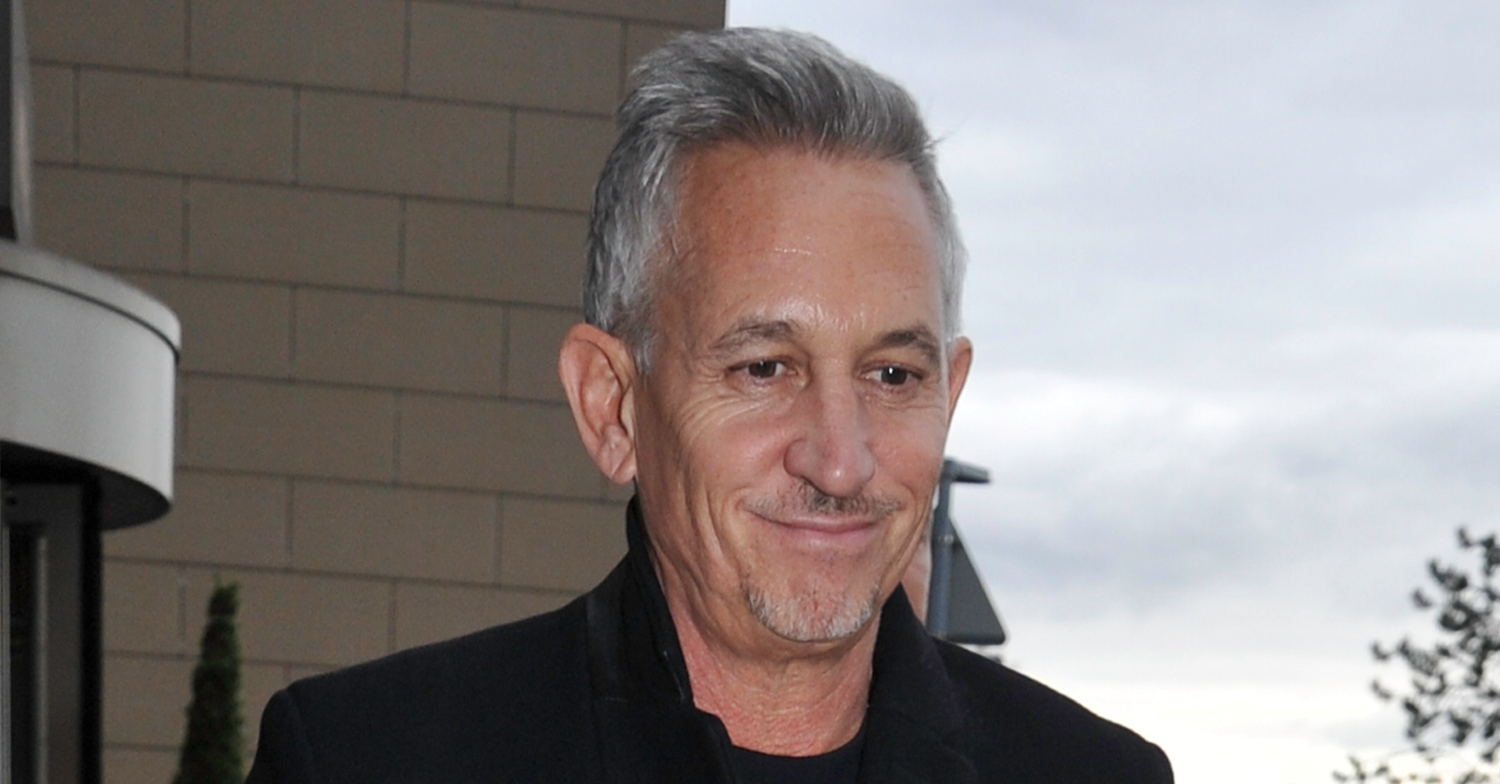 Gary Lineker looking down in the street in a coat