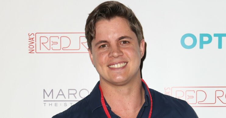 Johnny Ruffo smiling on the red carpet
