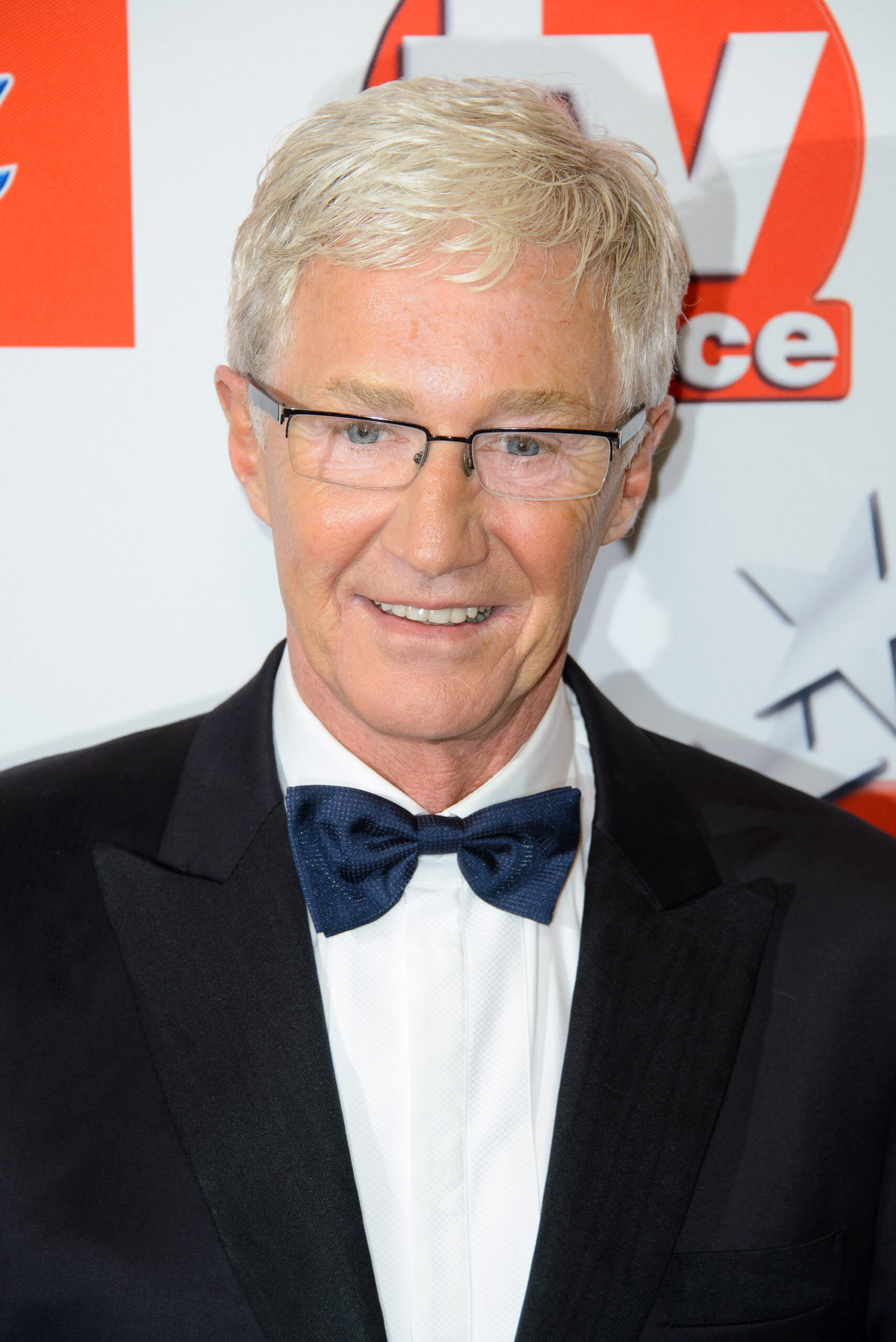 Paul O'Grady smiling on the red carpet