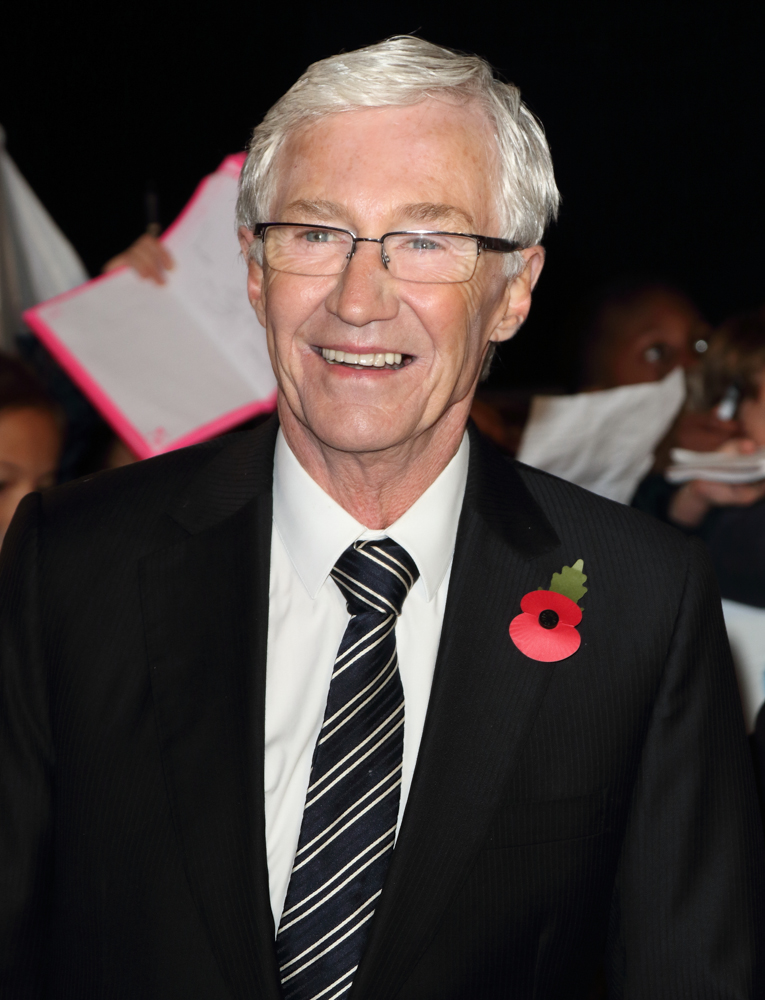 Paul O'Grady smiles on the red carpet 