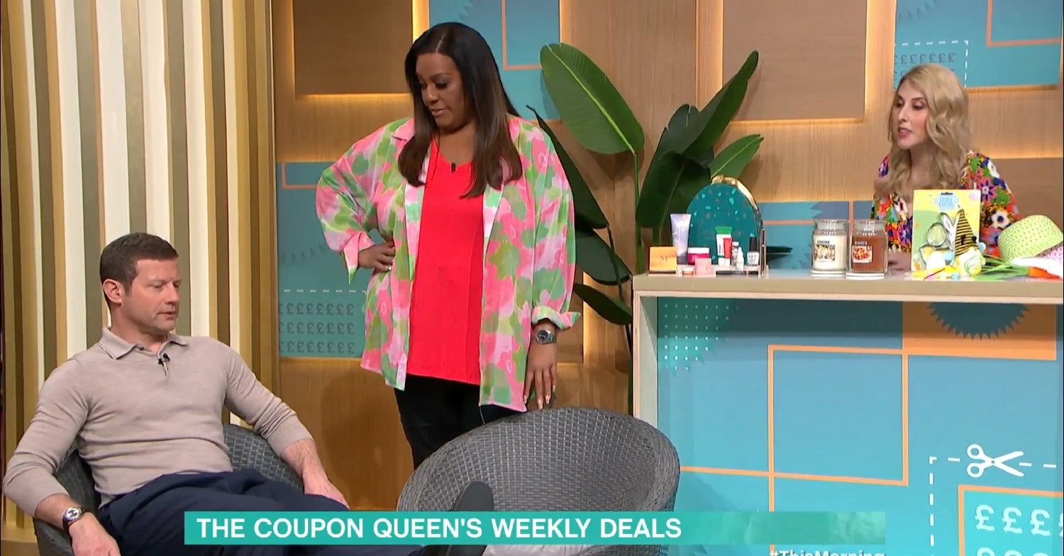 Alison Hammond looking at Dermot O'Leary, who's sitting down, whilst Holly Smith talks on This Morning today