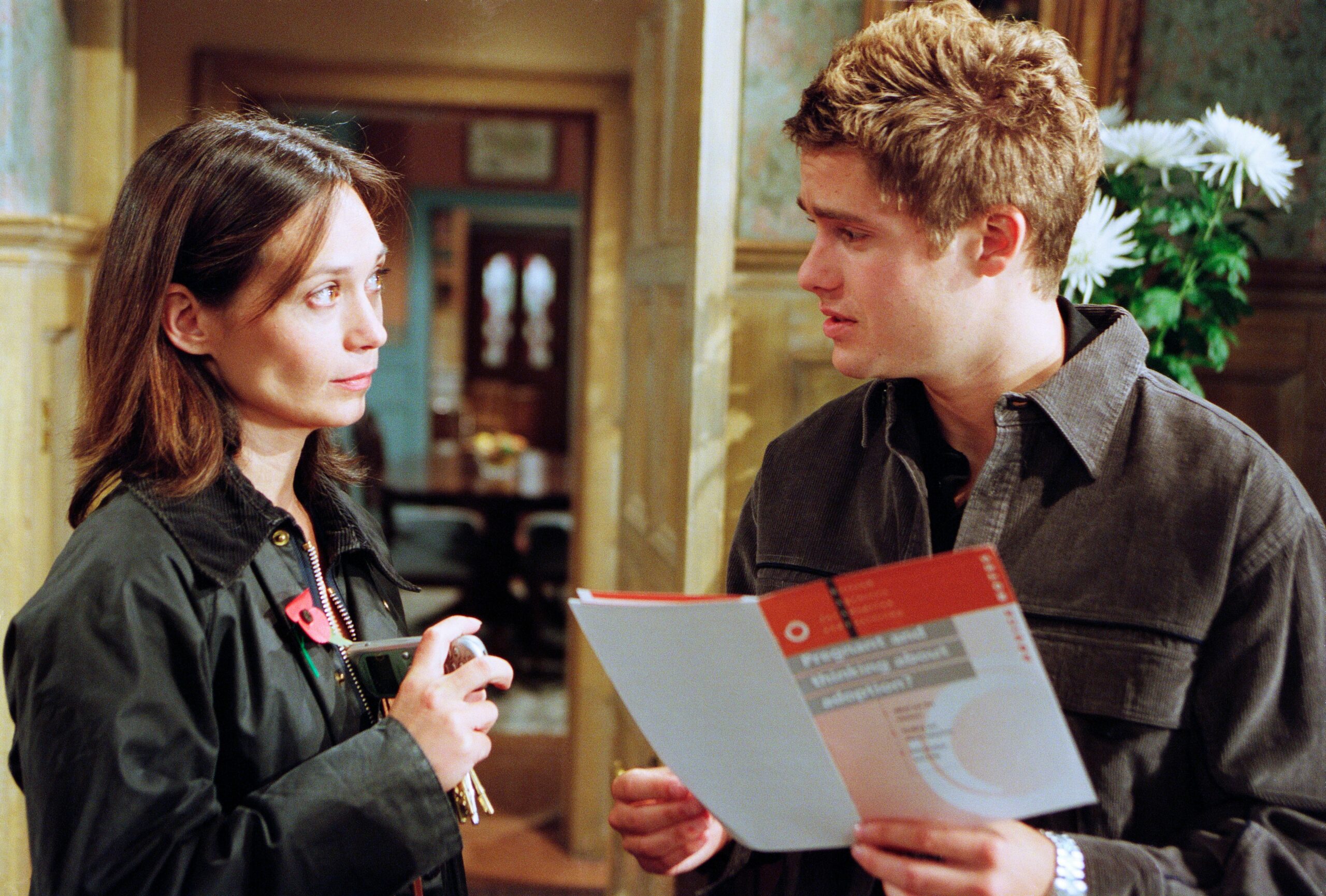 Scott and Zoe look at a leaflet about pregnancy in Emmerdale