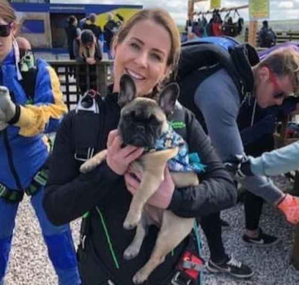 Clair Armstrong holding a pug smiling