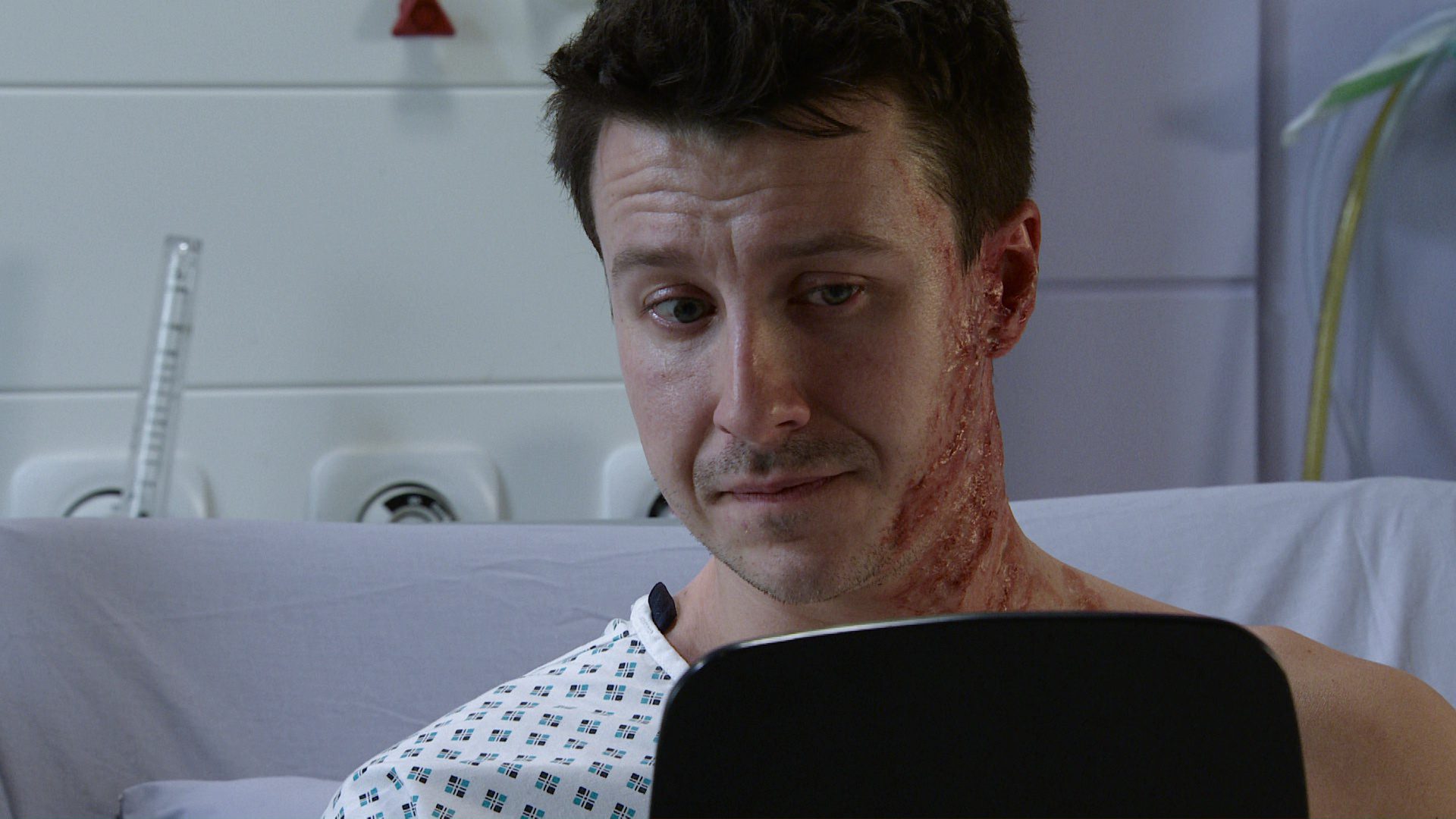 Ryan looks at himself in a mirror on Coronation Street