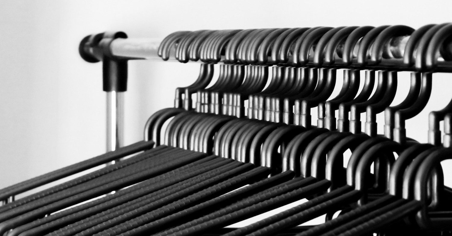 Clothes hangers hanging on a rail