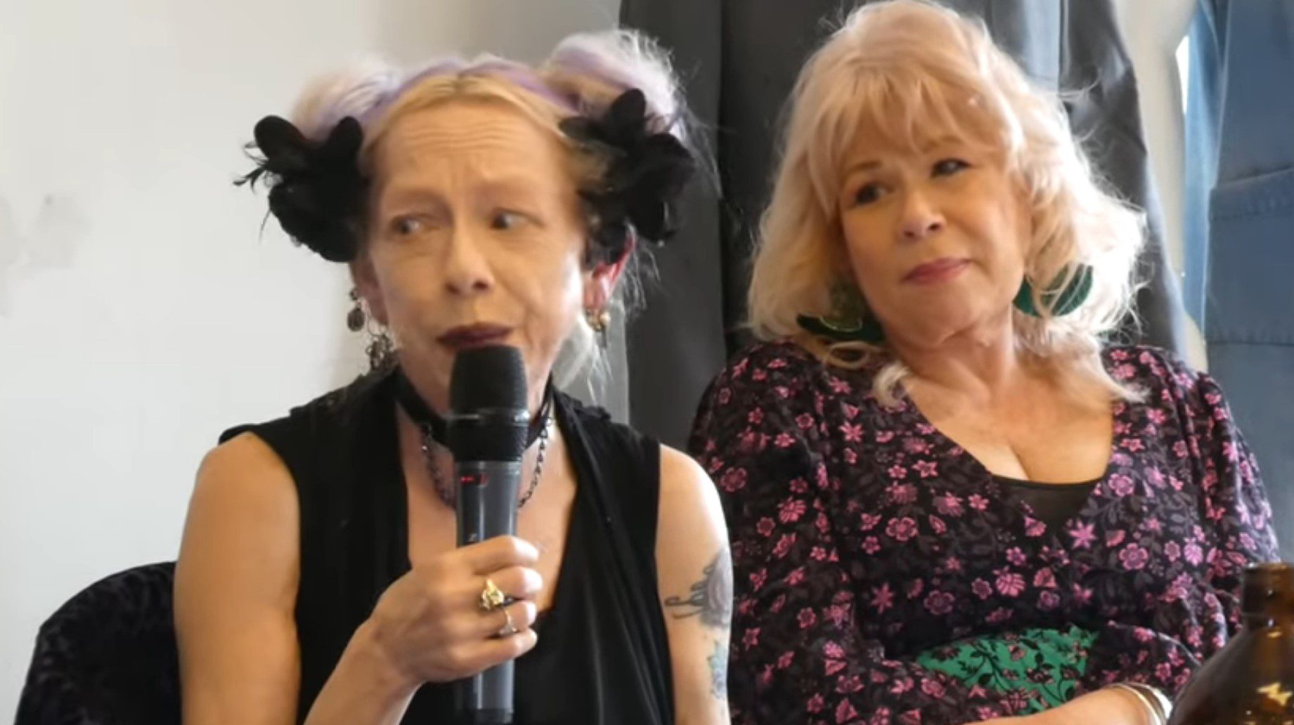 Maxine Klibingaitis talks into a microphone on a panel about Prisoner