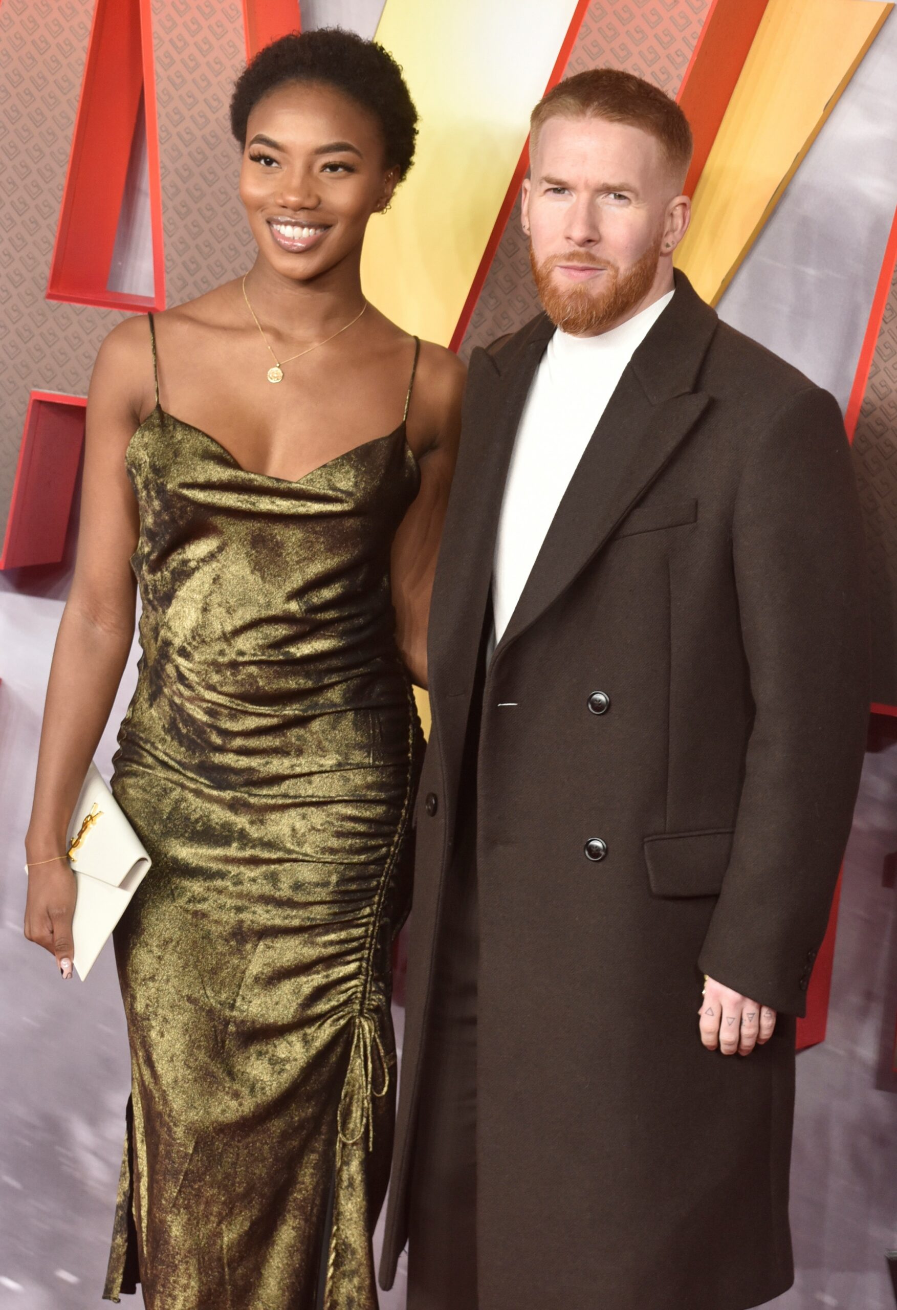 Neil Jones and Chyna Mills smiling at premiere