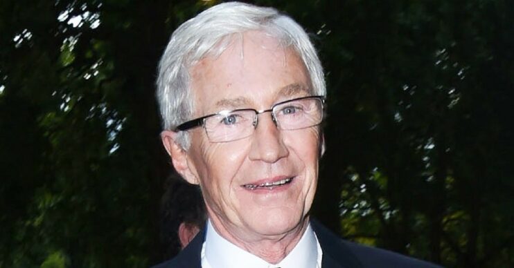 Paul O'Grady smiles on the way to an awards ceremony - his cause of death has been revealed