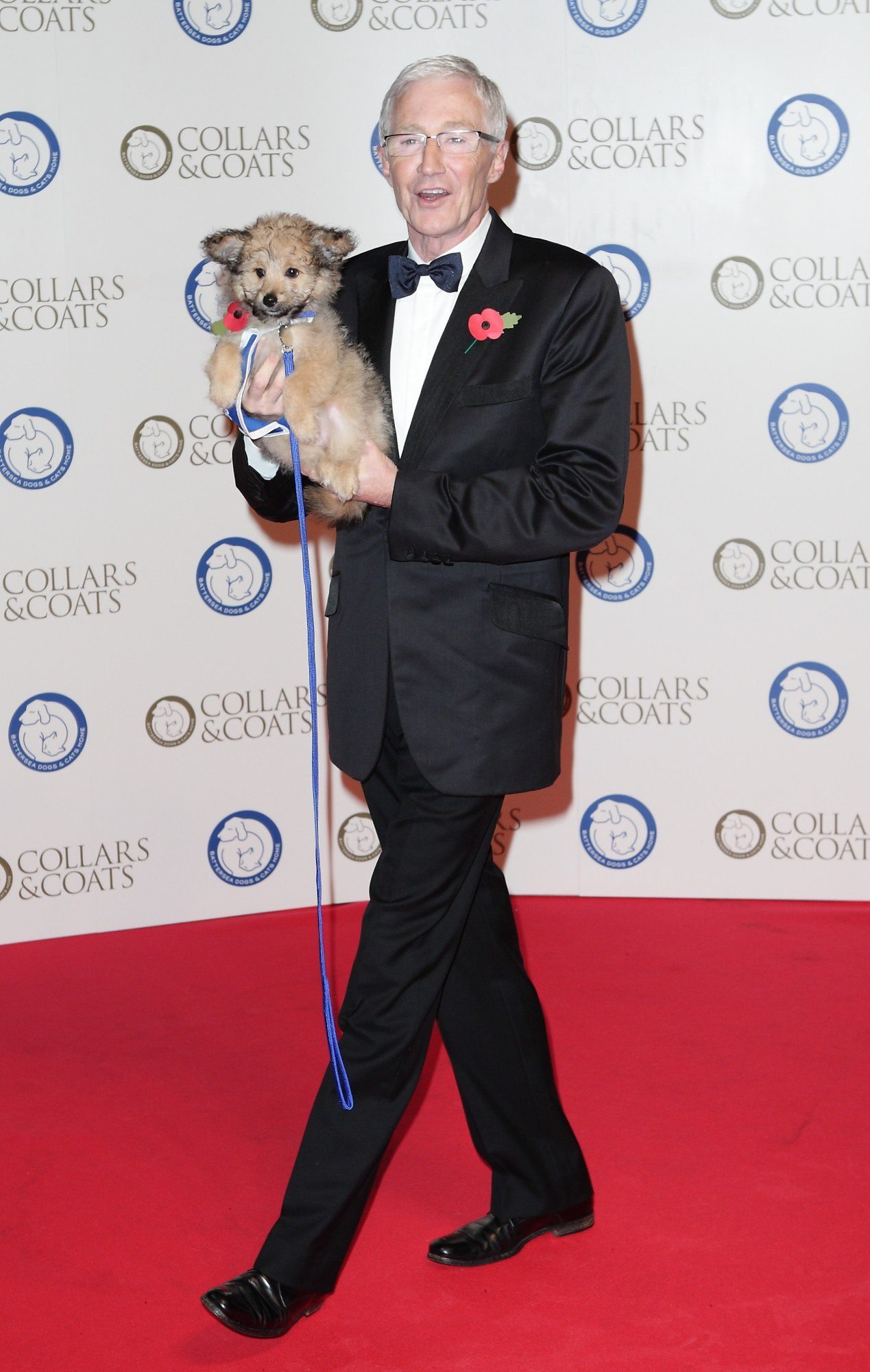 Paul O'Grady holding a dog