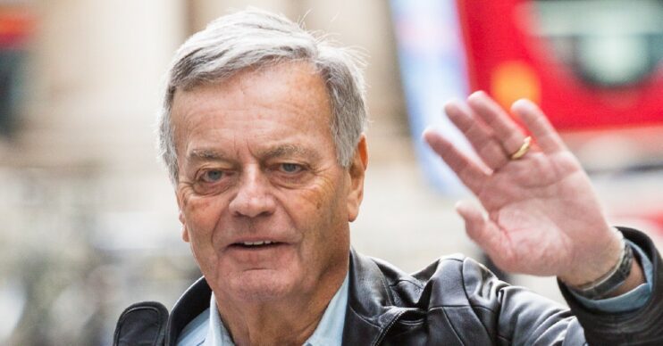 Tony Blackburn waves at photographers