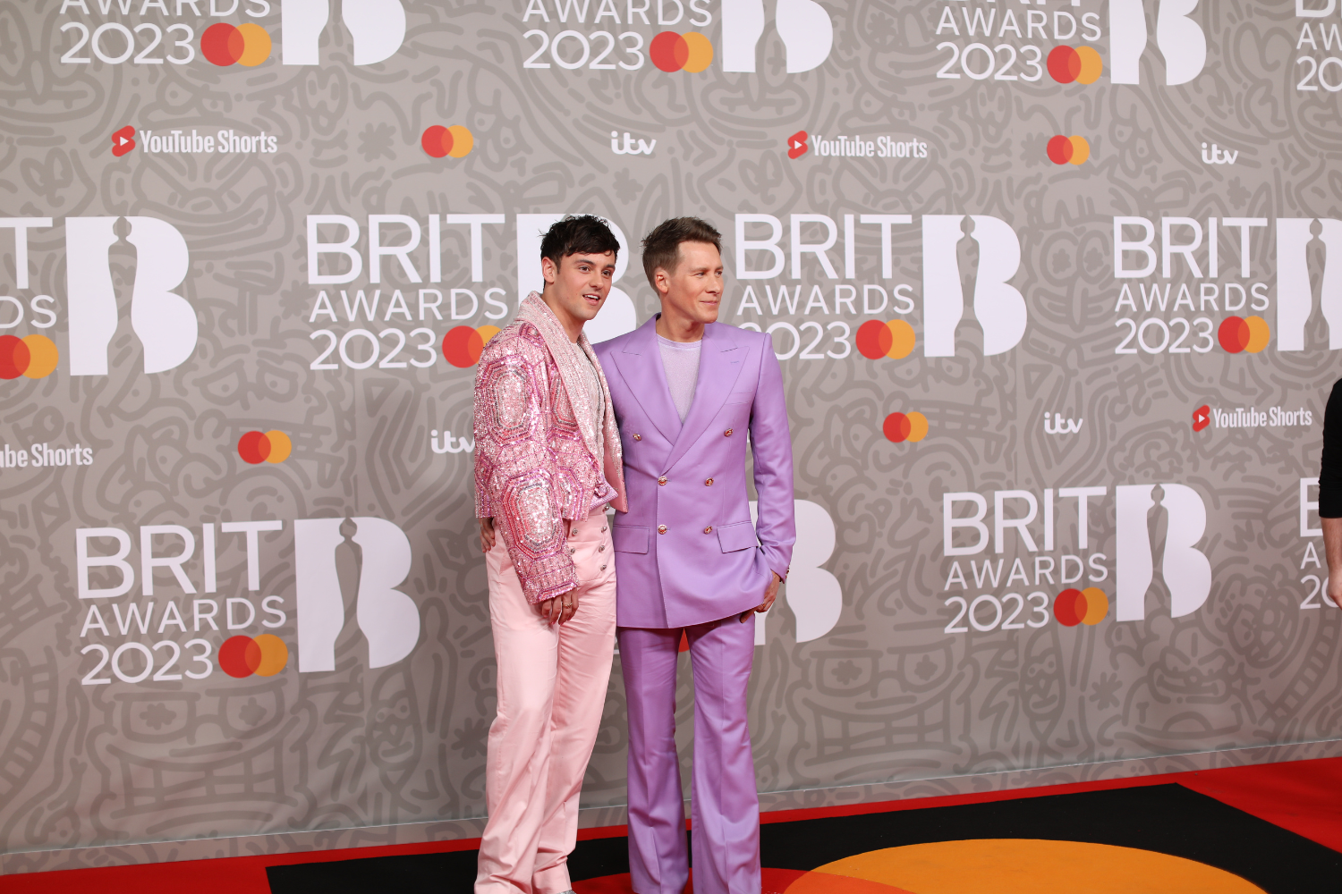 Tom Daley wearing pink on the Brits red carpet with his husband Dustin
