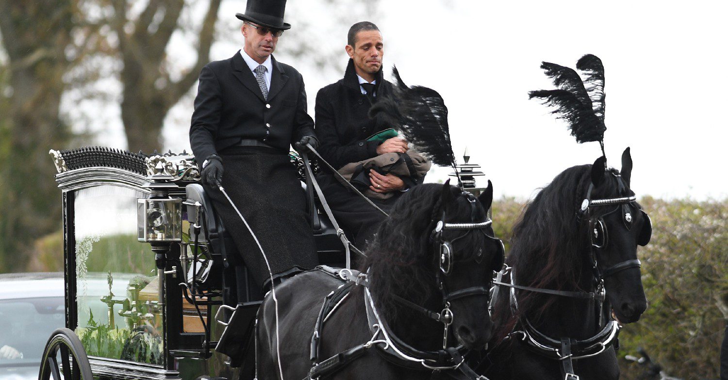Husband of Paul O'Grady riding horse-drawn carriage at his funeral