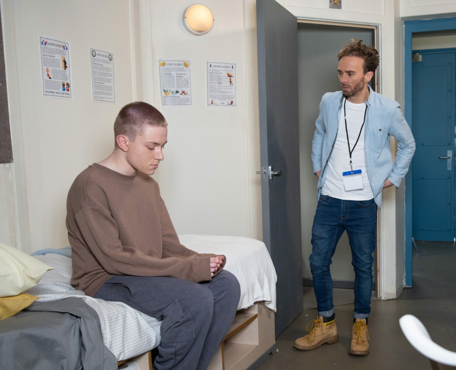 Max in Coronation Street sits in his cell looking unsure as David talks to him