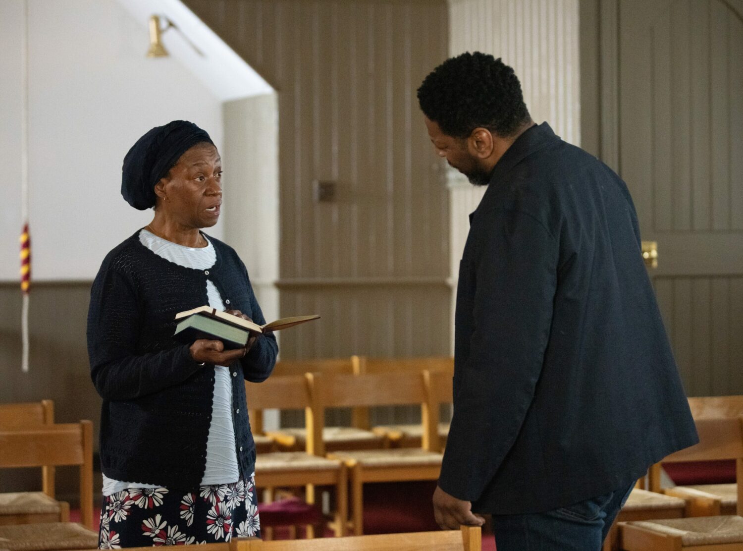 Emmerdale's Claudette is holding a Bible whilst criticising Charles in the Church