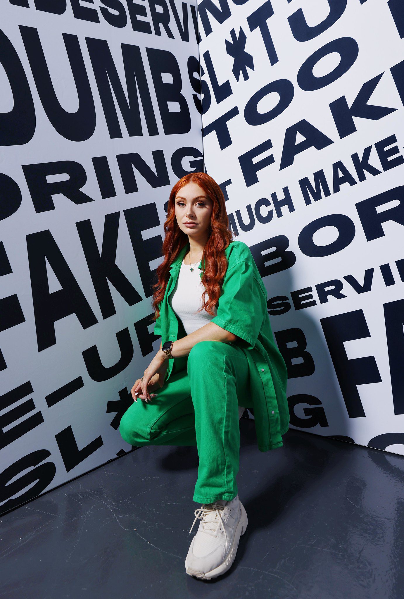 Woman posing in front of poster