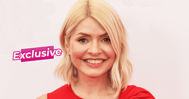 Holly Willoughby smiling in a red dress