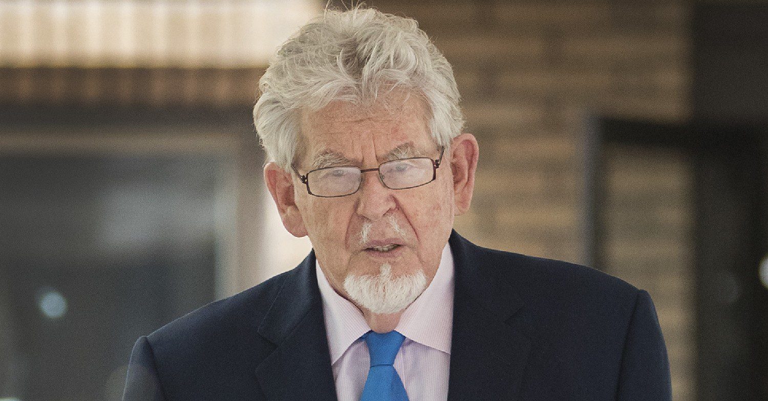 Rolf Harris looking serious in suit