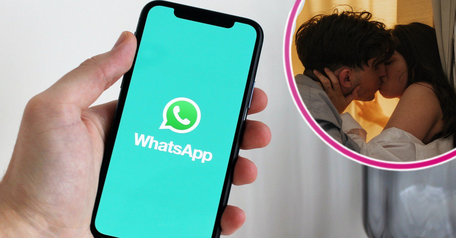 A phone with the WhatsApp logo app and two people kissing