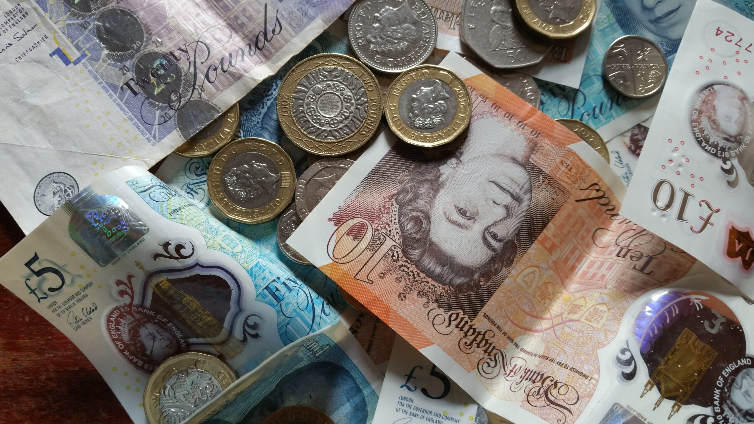Pound coins and notes on a table