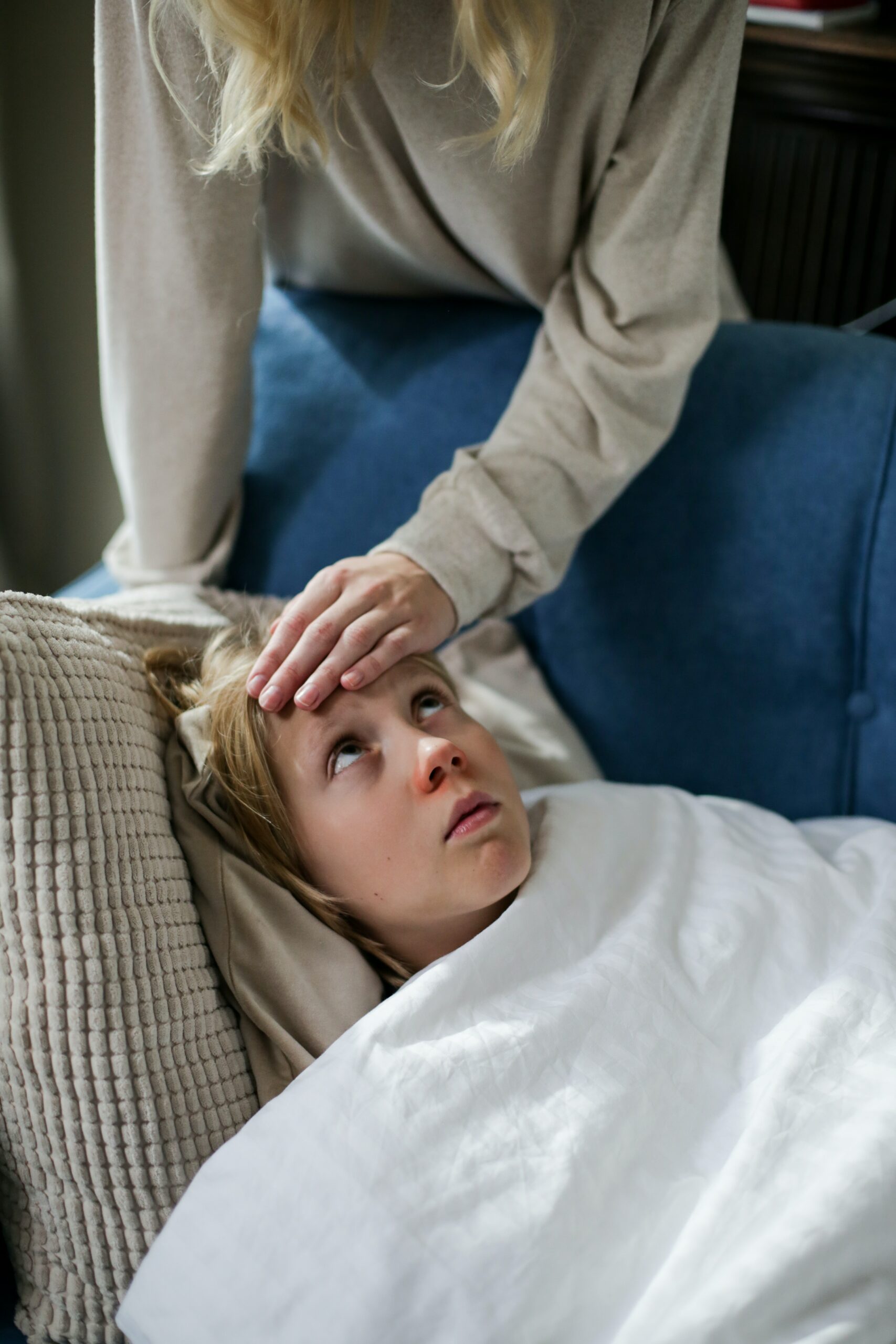 Sick child looks up at parent