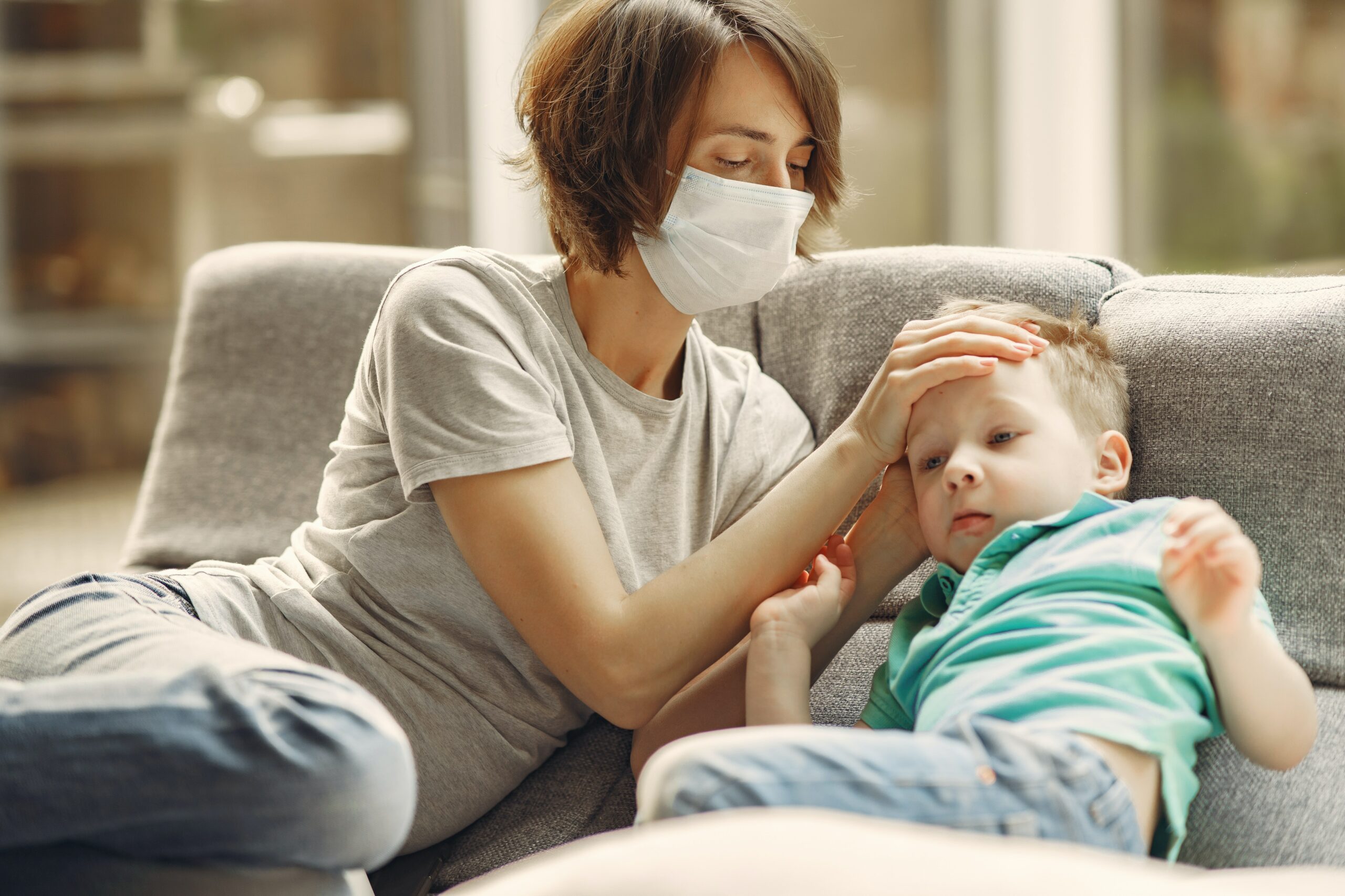 Parent checks sick child's fever