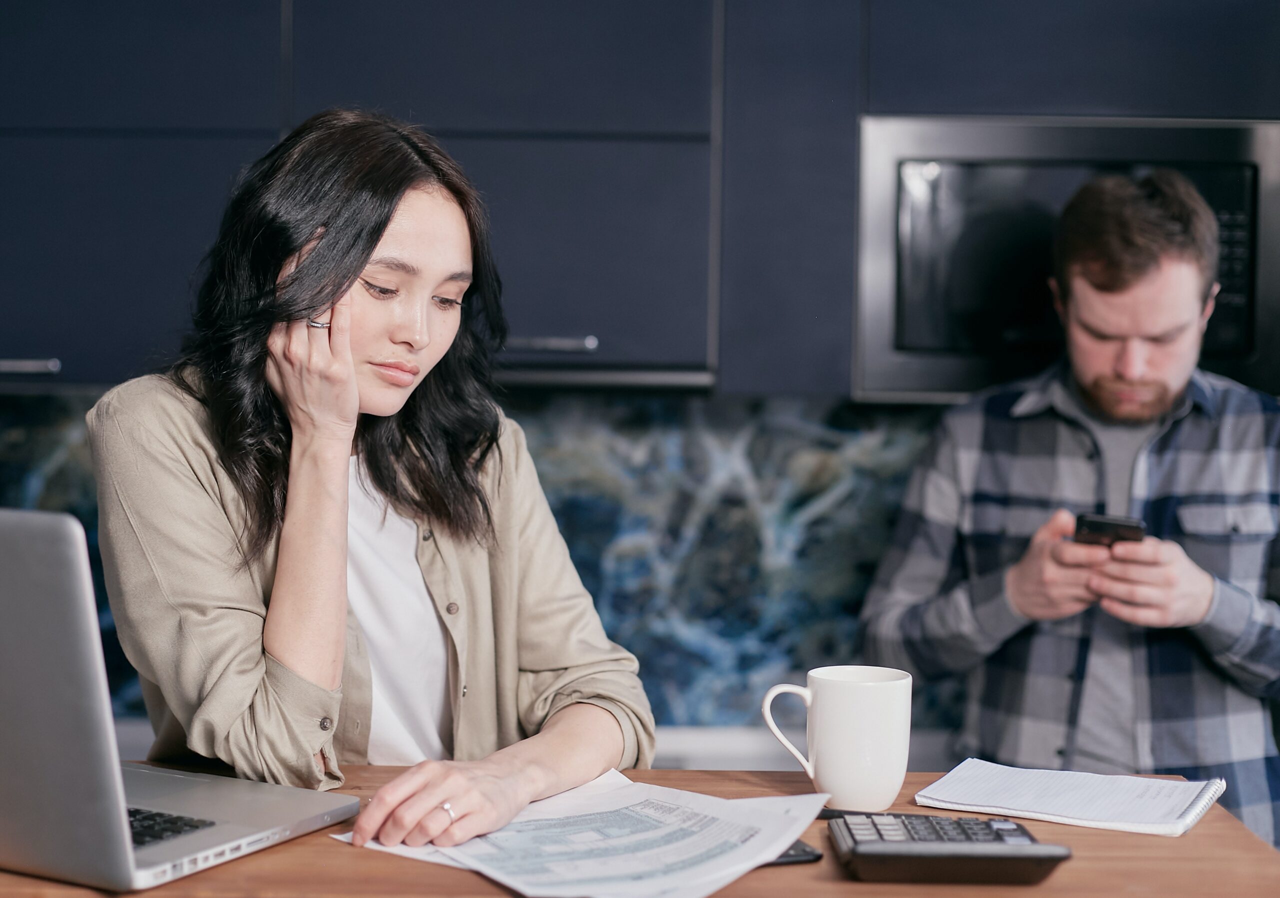 A woman is stressed over bills