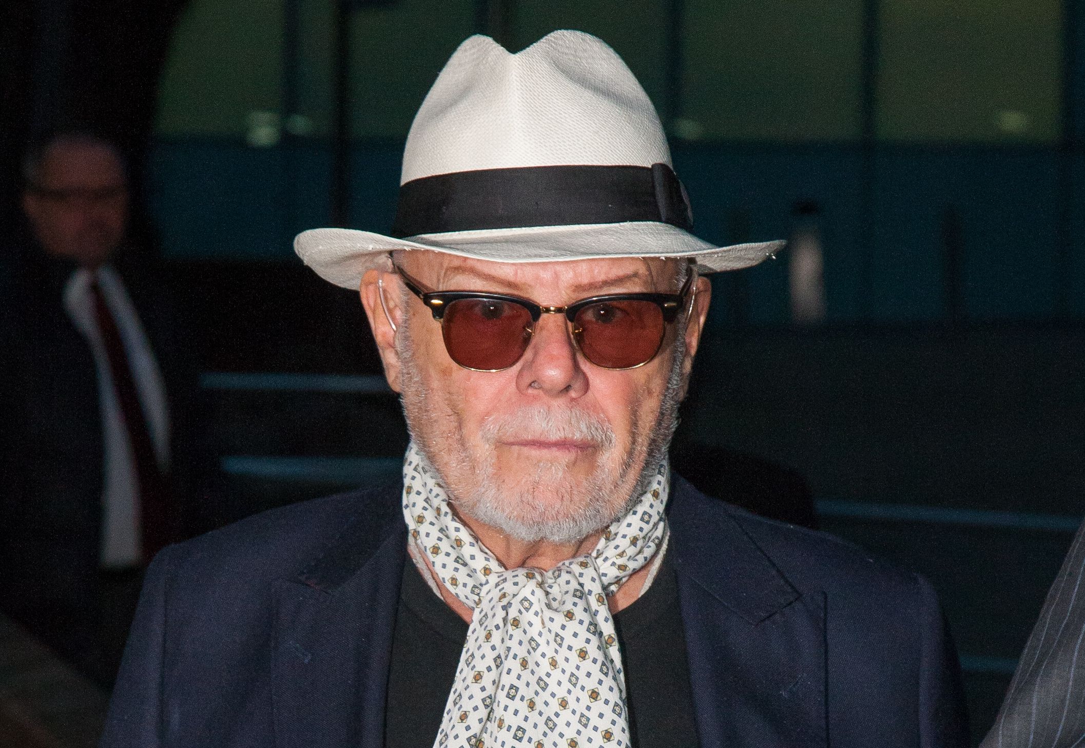 Gary Glitter in panama hat and singlasses