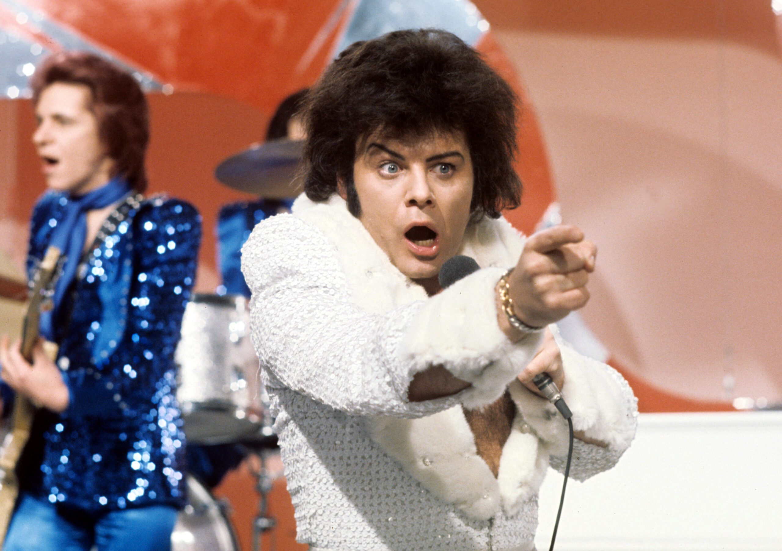 Gary Glitter performing in white outfit