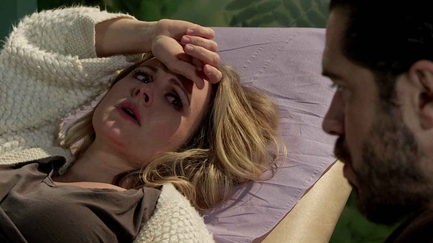 Sarah Barlow looks worried and upset with her hand on her forehead as she waits for her scan