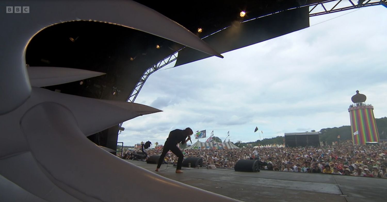 Singer Billy Nomates on stage performing at Glastonbury