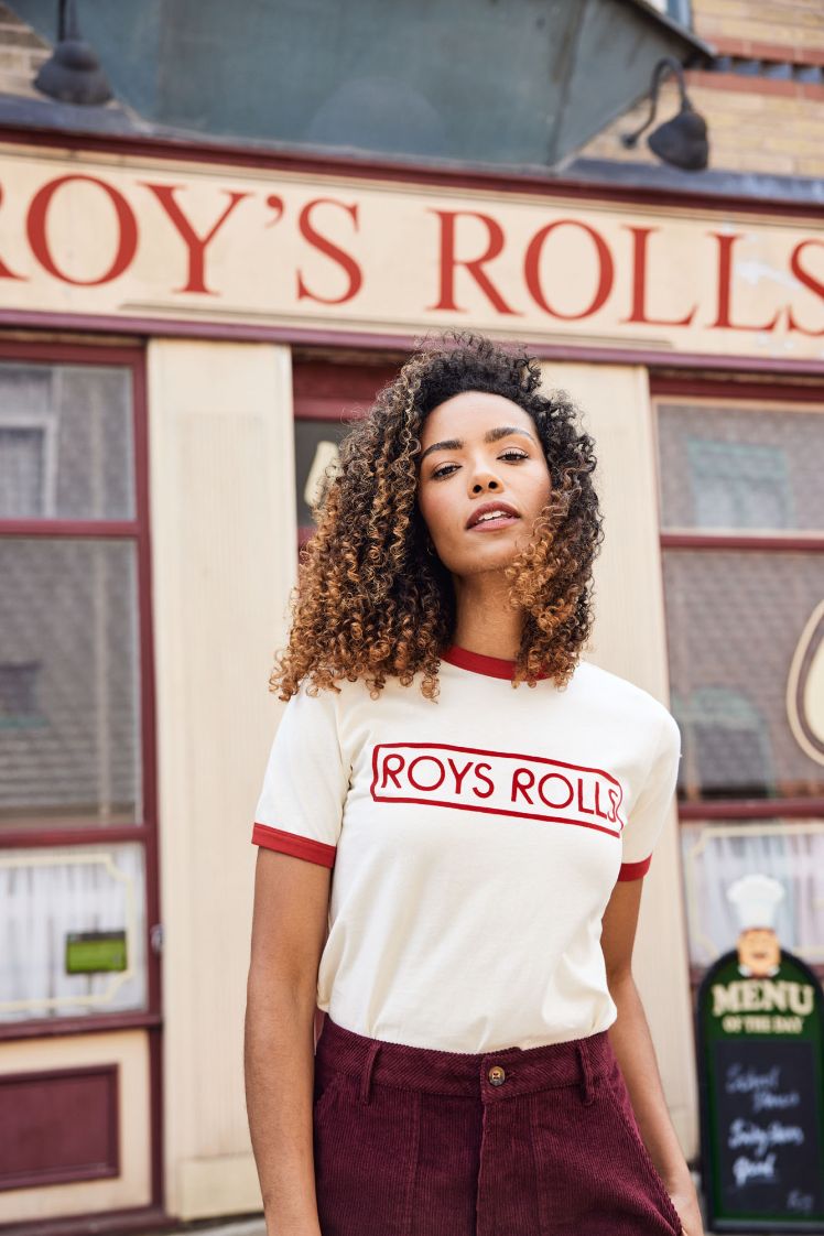 Coronation Street's Roy's Rolls with a model standing outside wearing a Roy's Rolls t-shirt