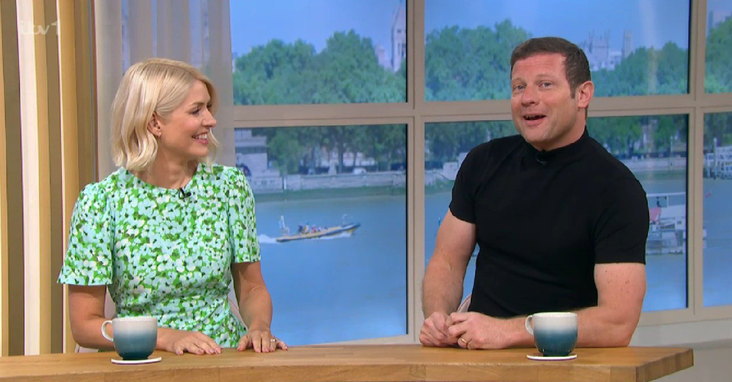 Holly Willoughby smiling at Dermot O'Leary who's talking on This Morning