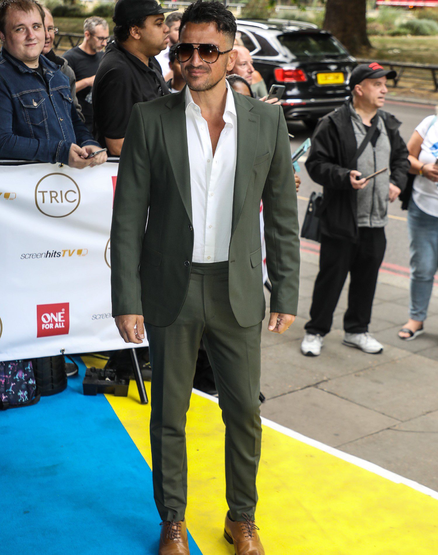 Peter Andre smiling in sunglasses at TRIC Awards