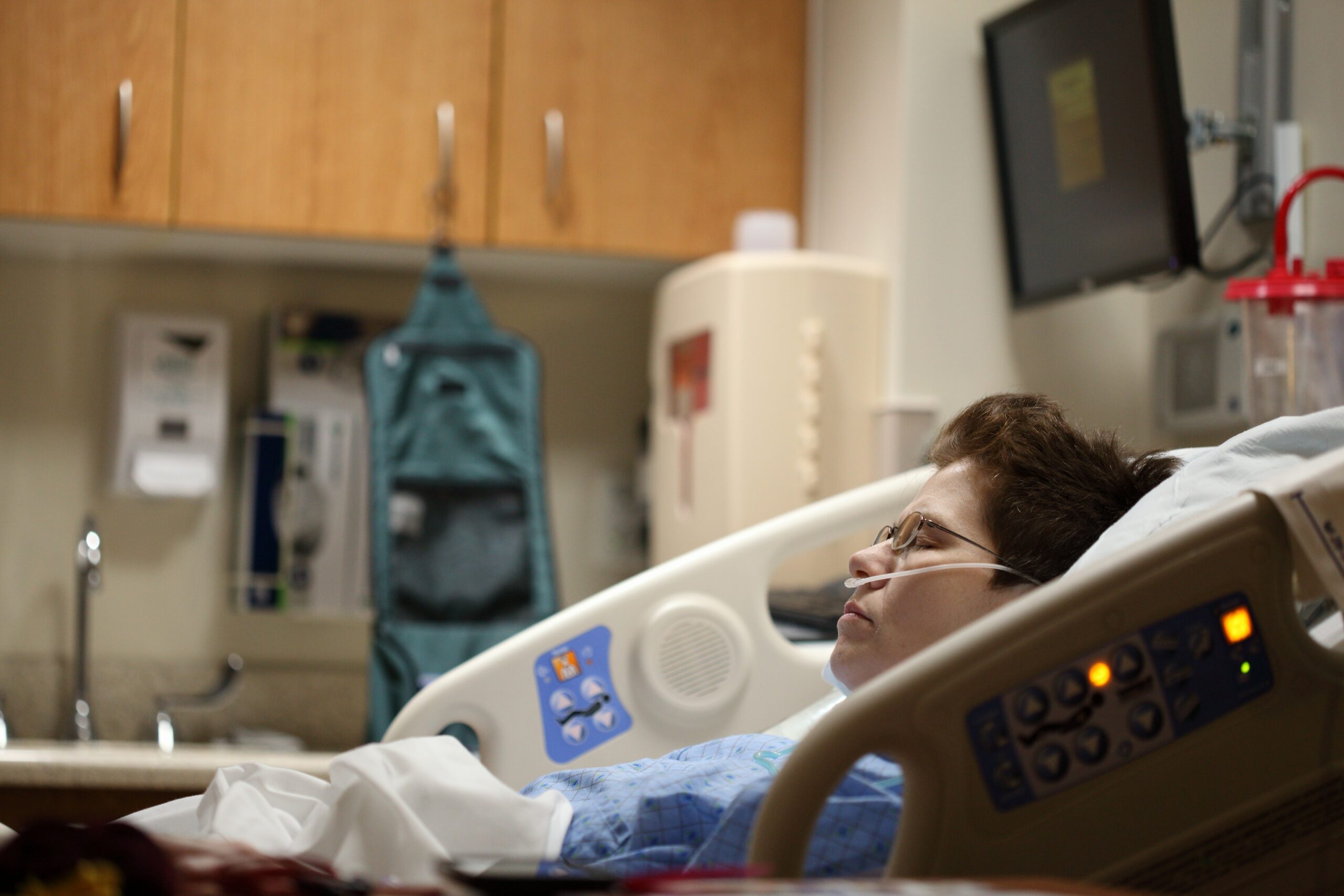 Patient lies in a hospital bed