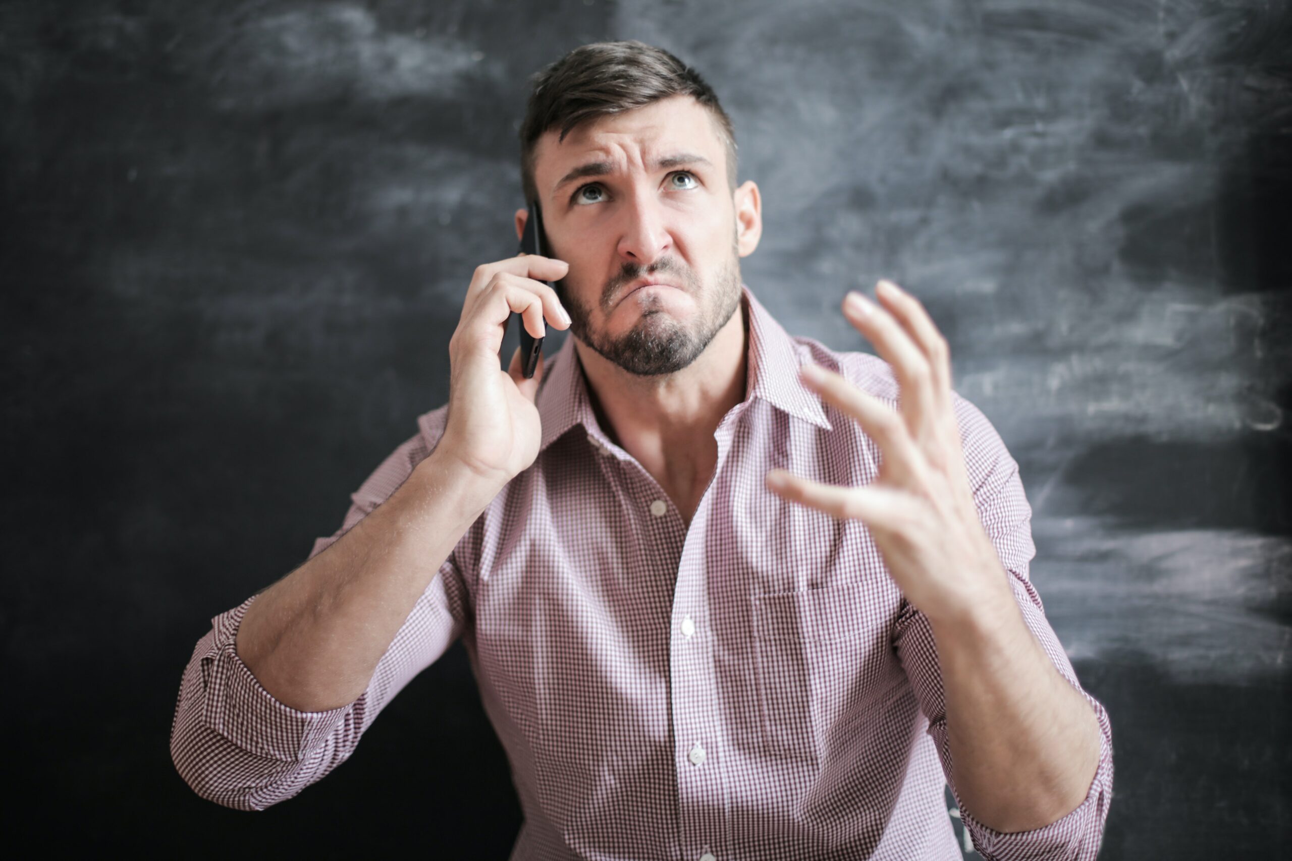 Angry man speaks on phone