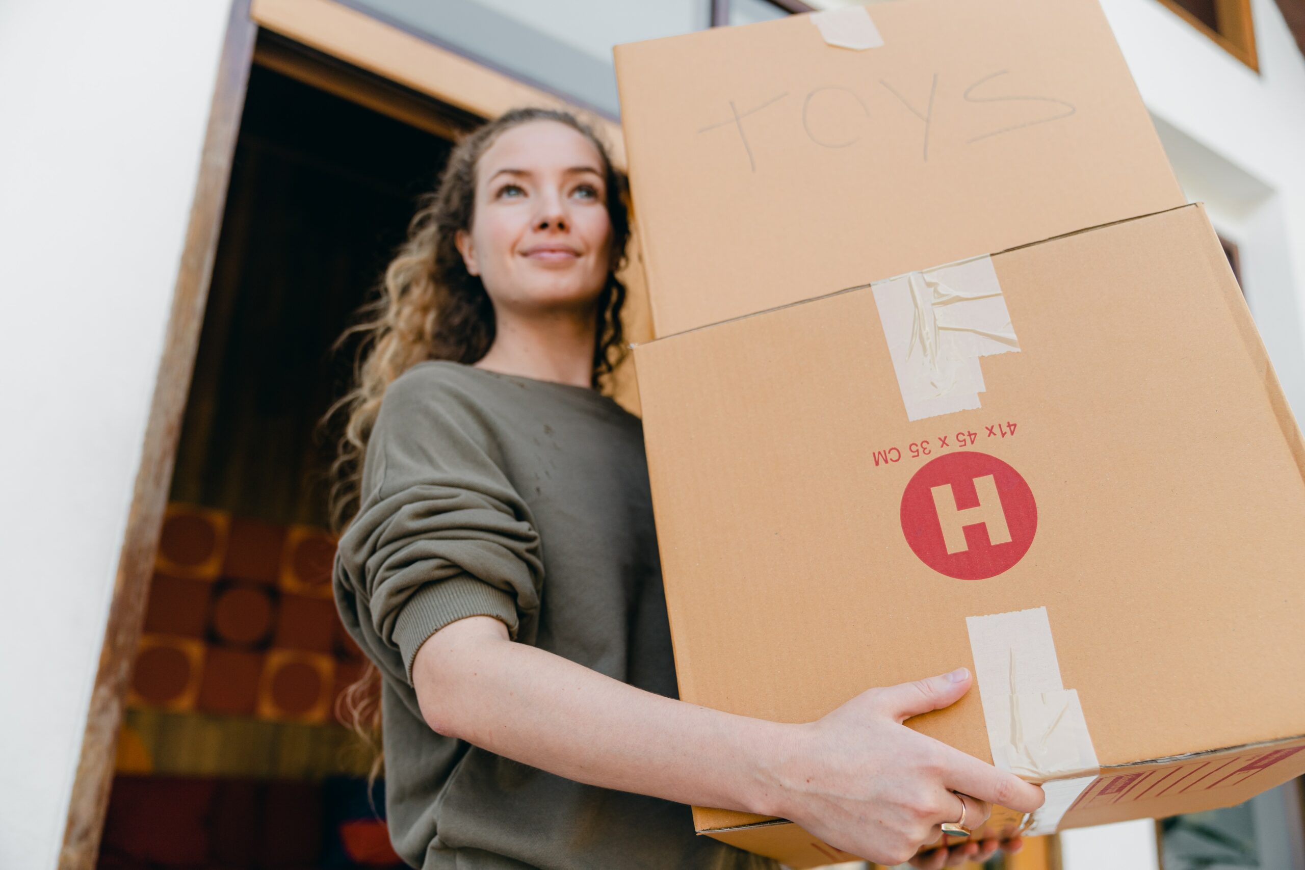 Woman walks out with boxes