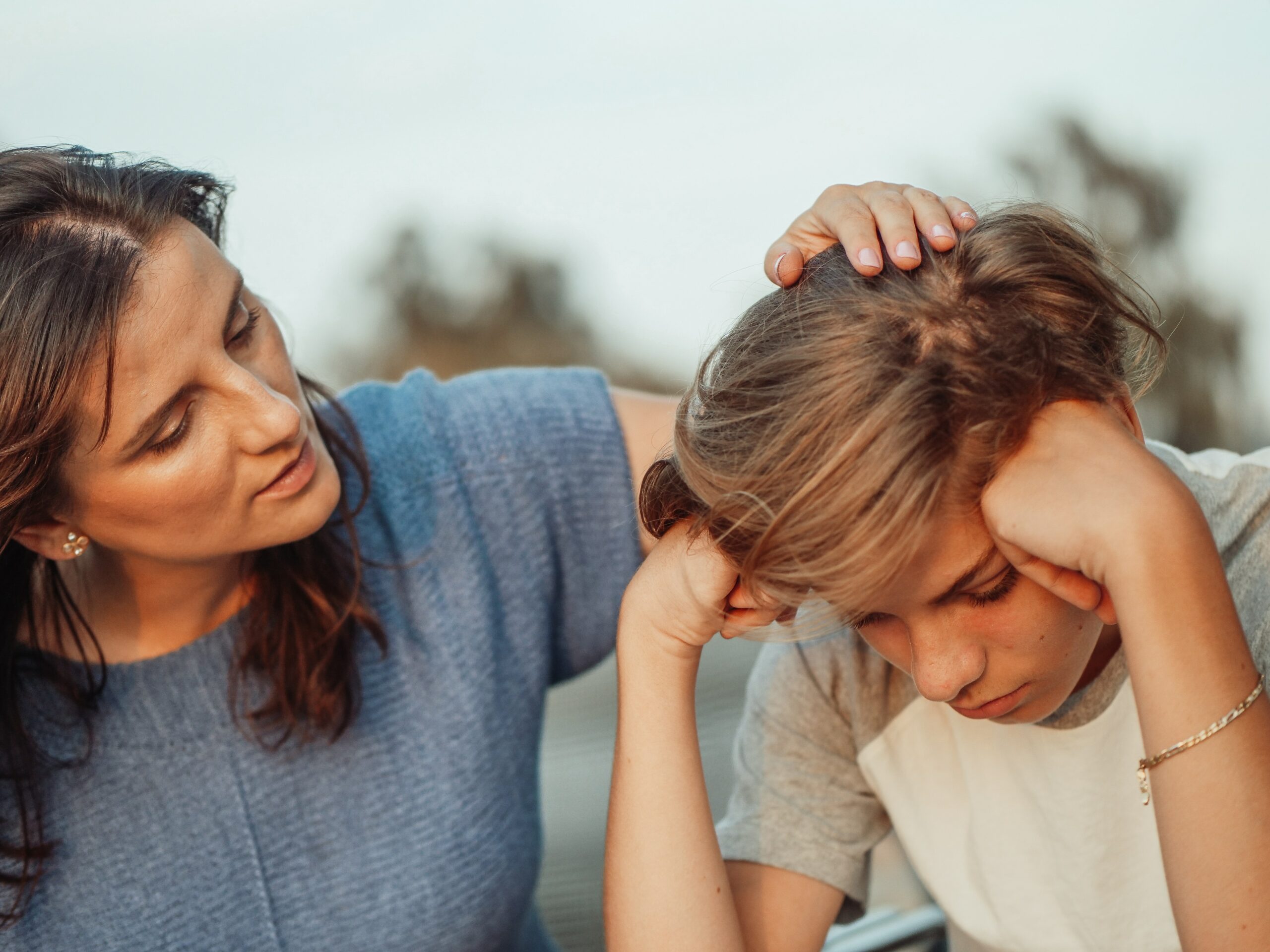 Mother comforts young boy