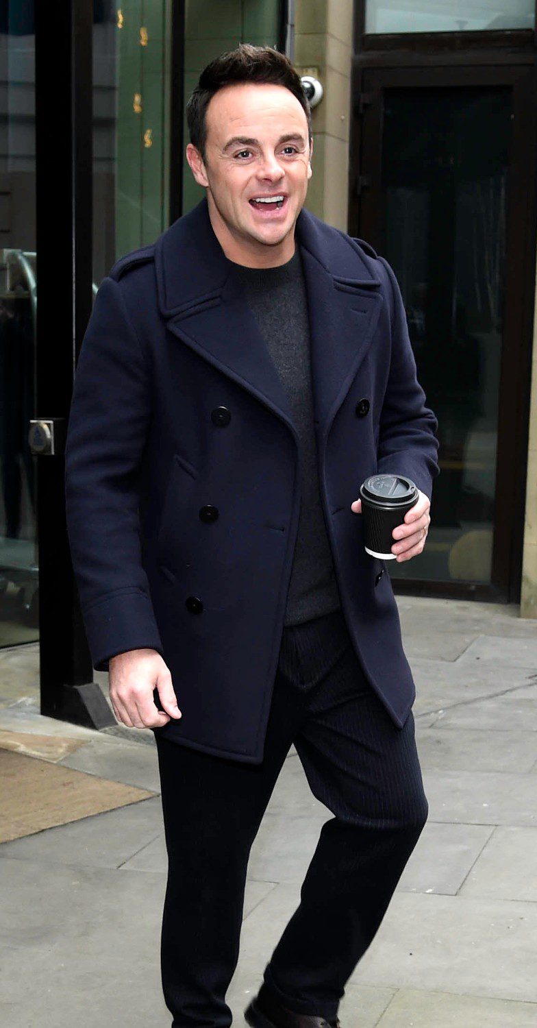 Ant McPartlin in the street holding a coffee cup