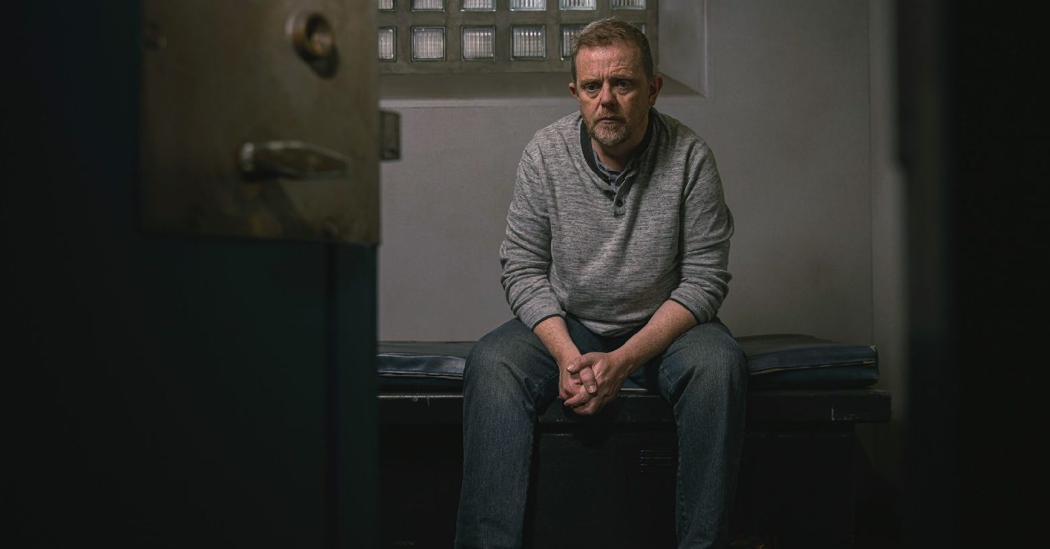 Emmerdale's Dan is sitting sadly in a cell