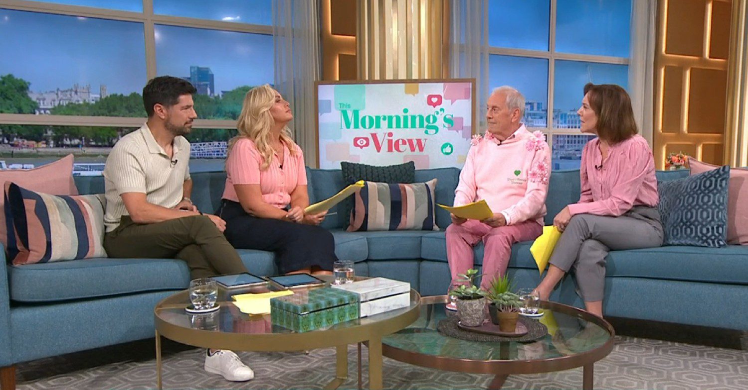 Gyles Brandreth talking on This Morning in a pink jumper along with the show's hosts