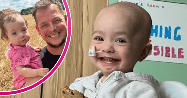 Little girl smiling in hospital and being held by her dad