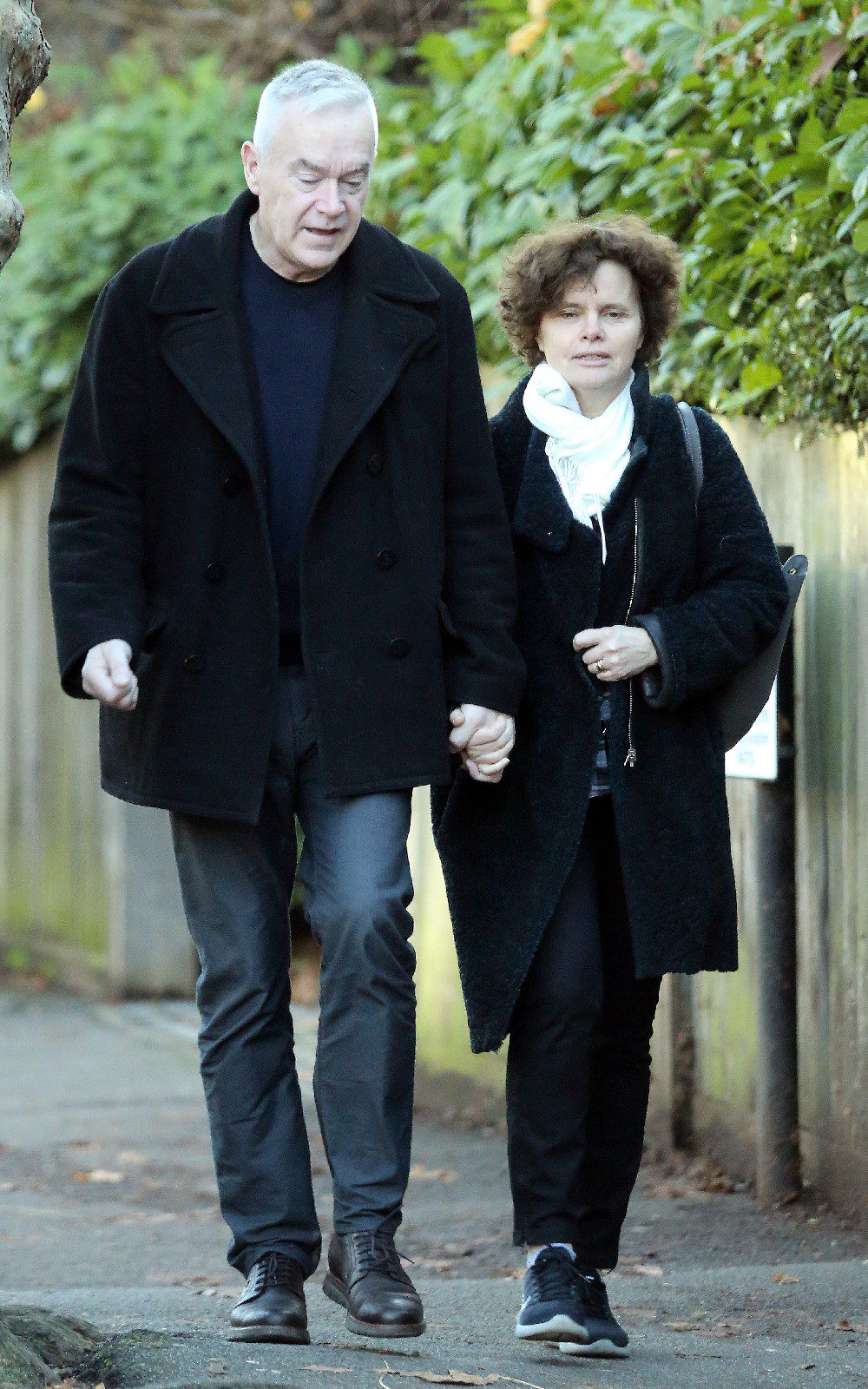 Huw Edwards and his wife Vicky Flind walking hand in hand