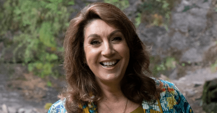 Jane McDonald smiling in the forest