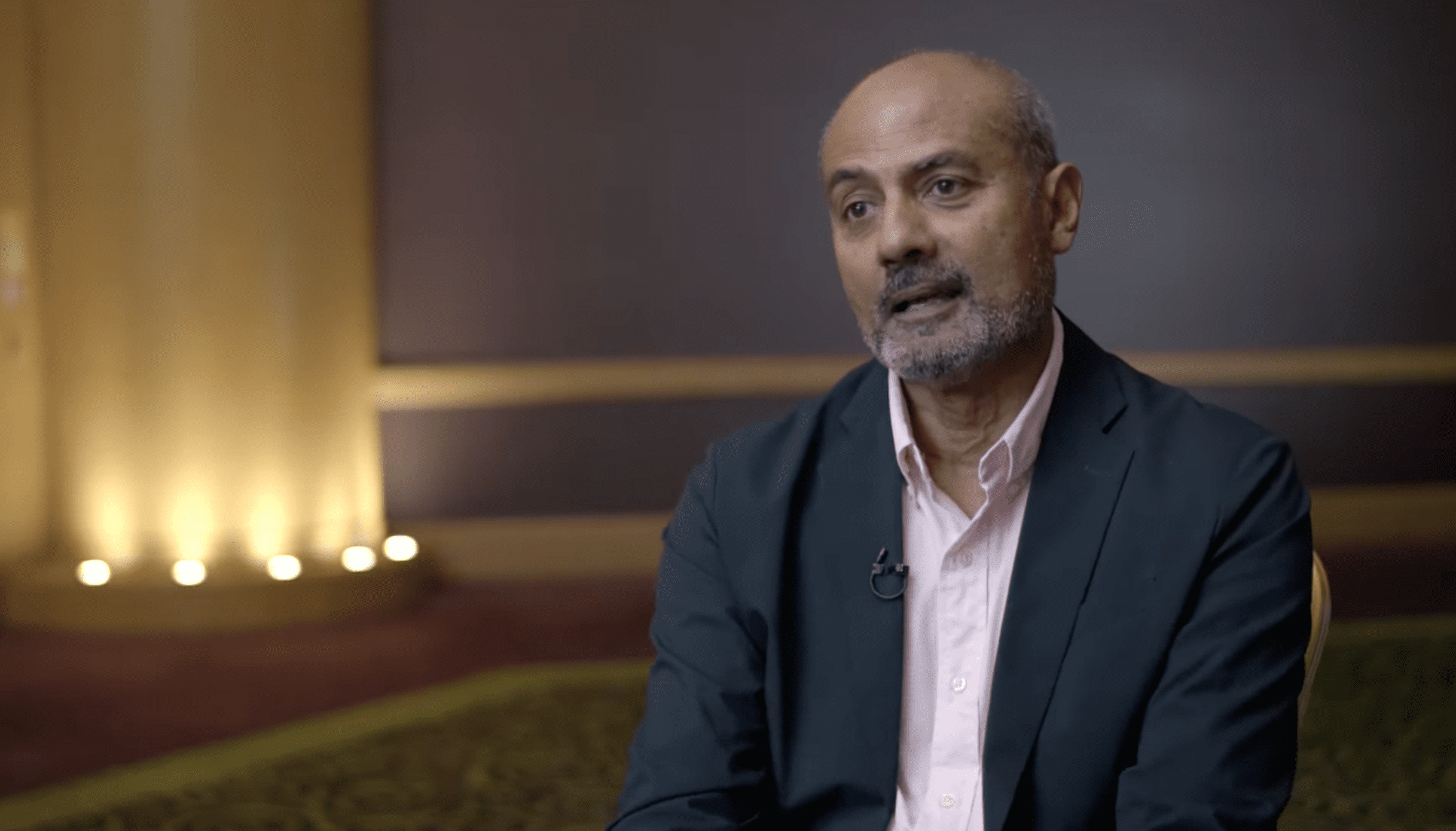 George Alagiah speaking to camera wearing a suit