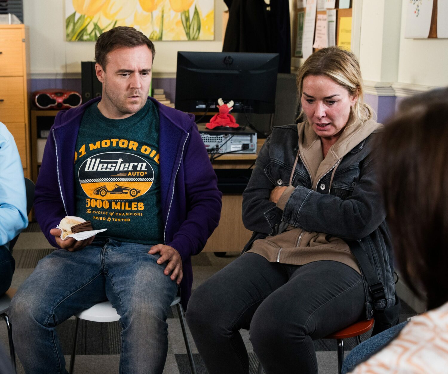 Coronation Street's Tyrone and Cassie are sitting together at the support group