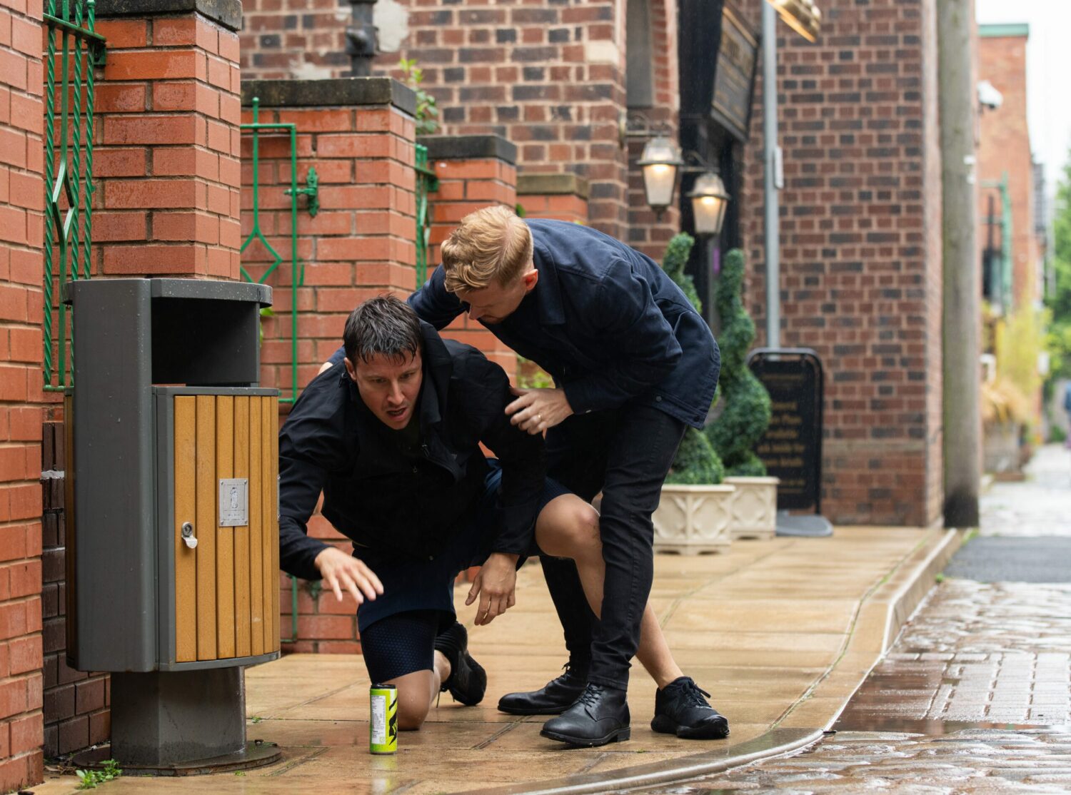 Gary is holding on to a collapsed Ryan outside