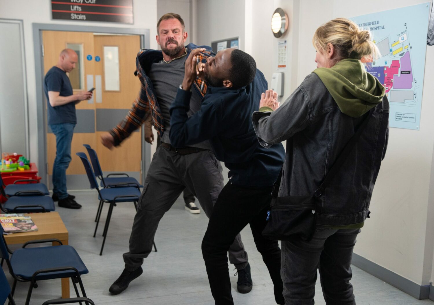 Michael in Corrie is punched by Dean as Cassie looks on